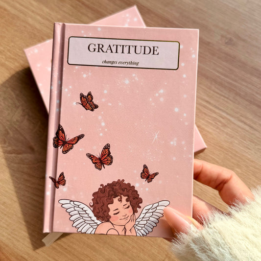 Open gratitude journal by Inwords Gifting with sunshine-inspired cover and lined pages for daily reflections.