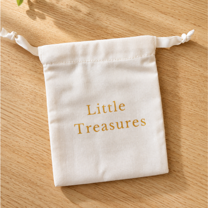 Set of three Inwords Gifting Memory Keeper Pouches in various colors, made of durable fabric for storing keepsakes and small items.