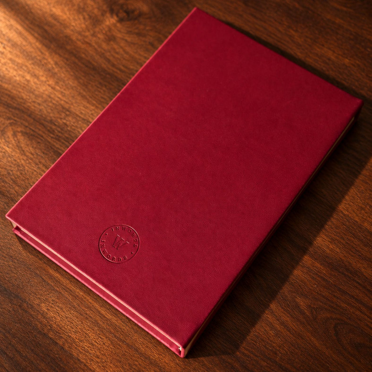 Burgundy Mémoire Journal by Inwords Gifting with elegant cover, open pages, and lined paper for writing memories or notes.