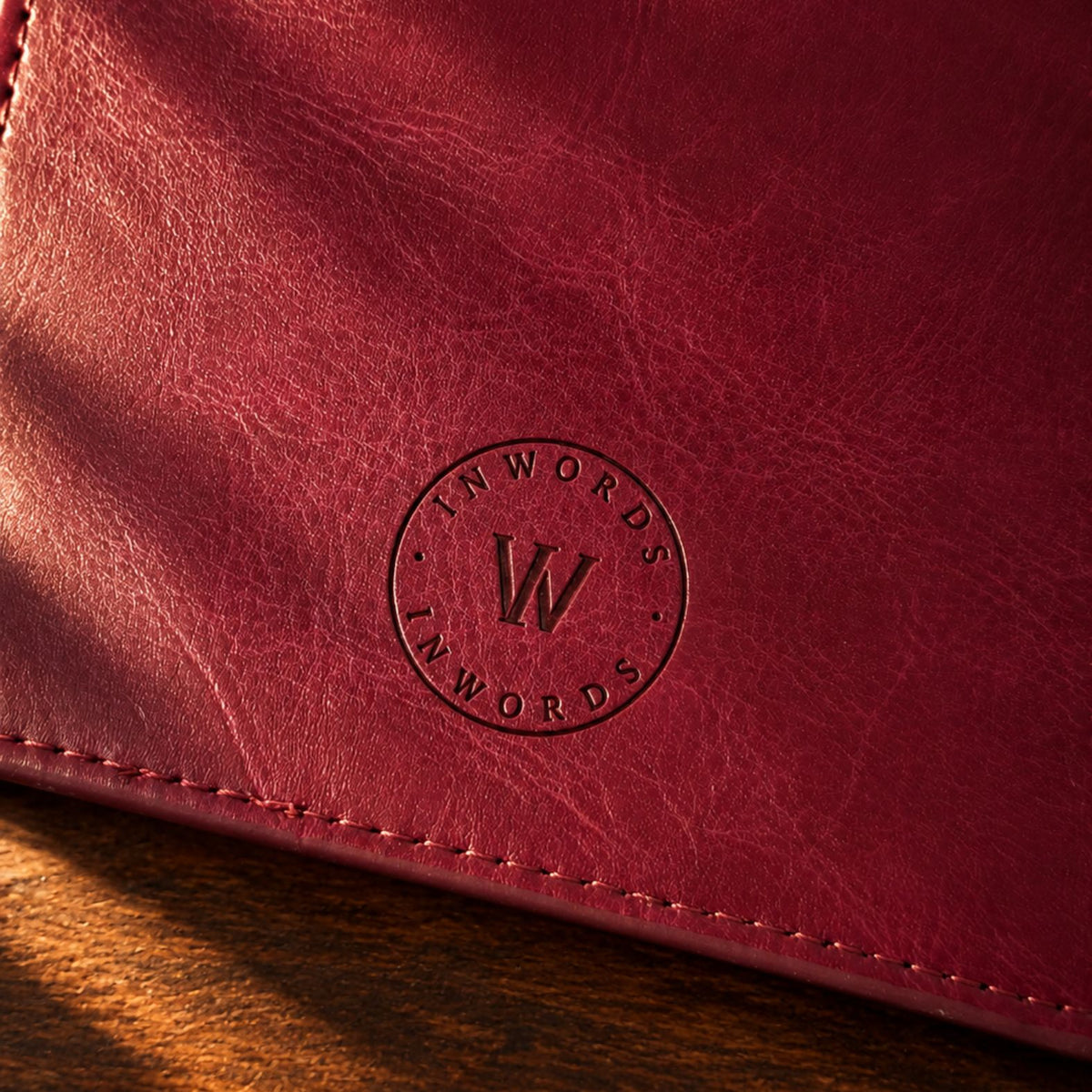 Burgundy leather-bound Mémoire Journal by Inwords Gifting with embossed cover and lined pages for personal writing.