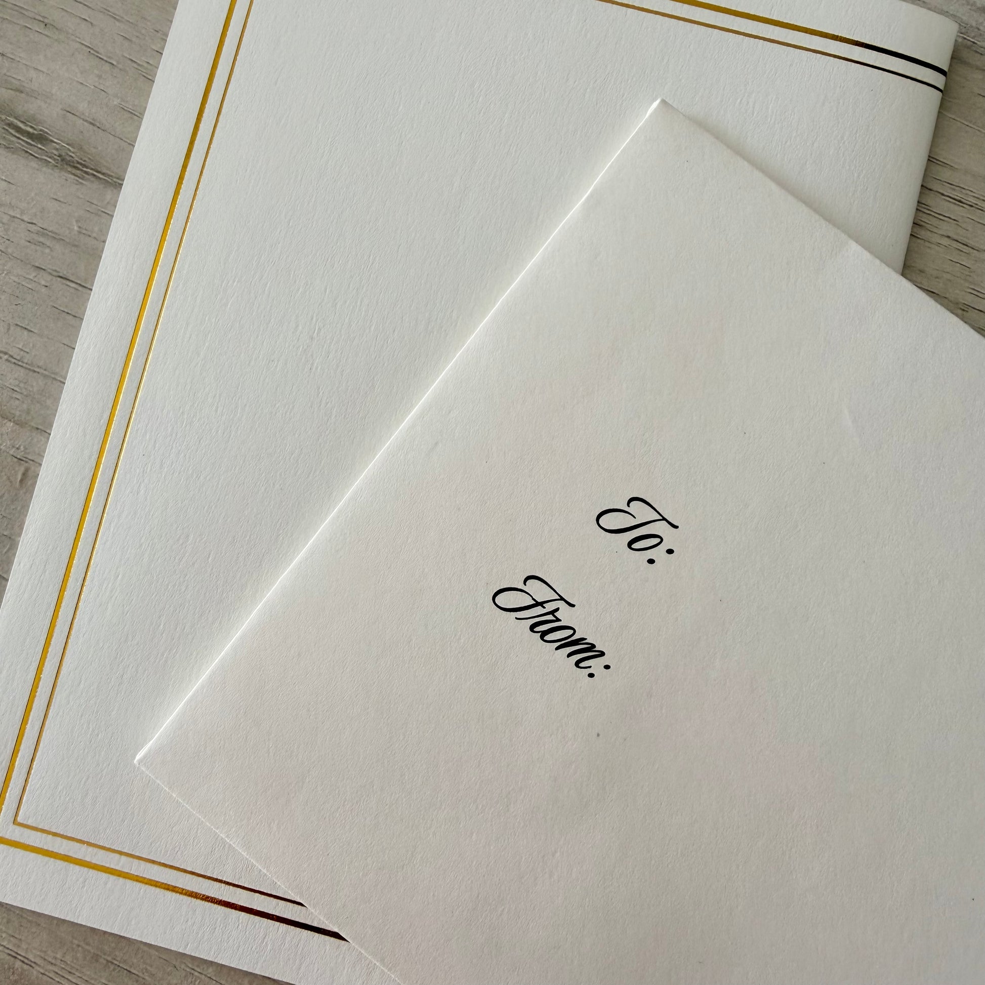 Inwords Gifting Forever Letters Keepsake Set with engraved metal letter charms and a leather-bound case, displayed on a wooden surface.