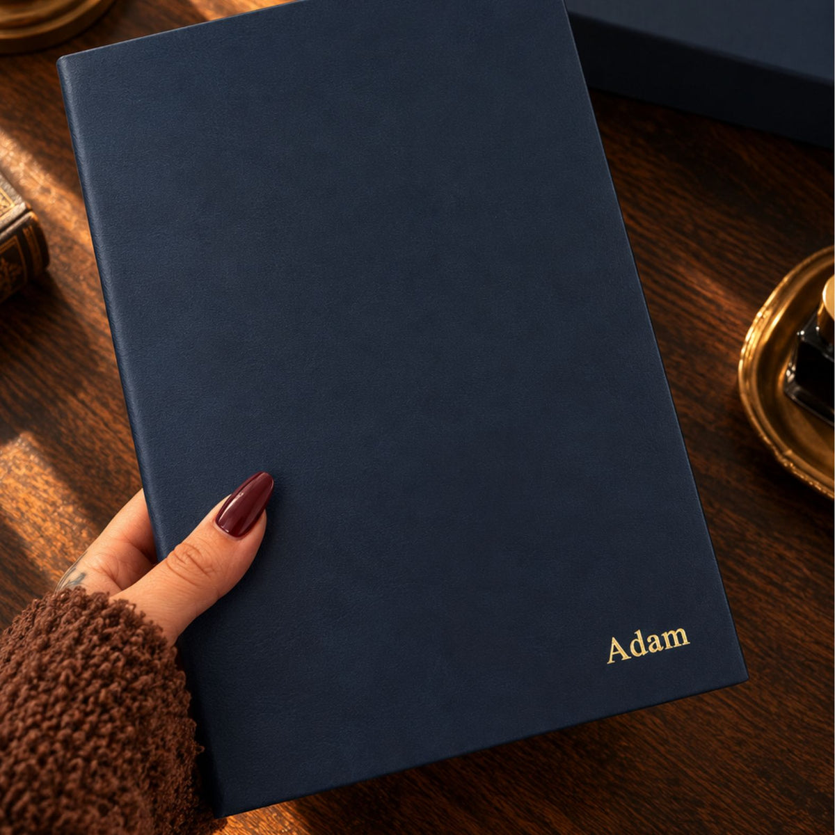 Navy blue Inwords Gifting Mémoire Journal with textured cover and gold embossed lettering on the front.