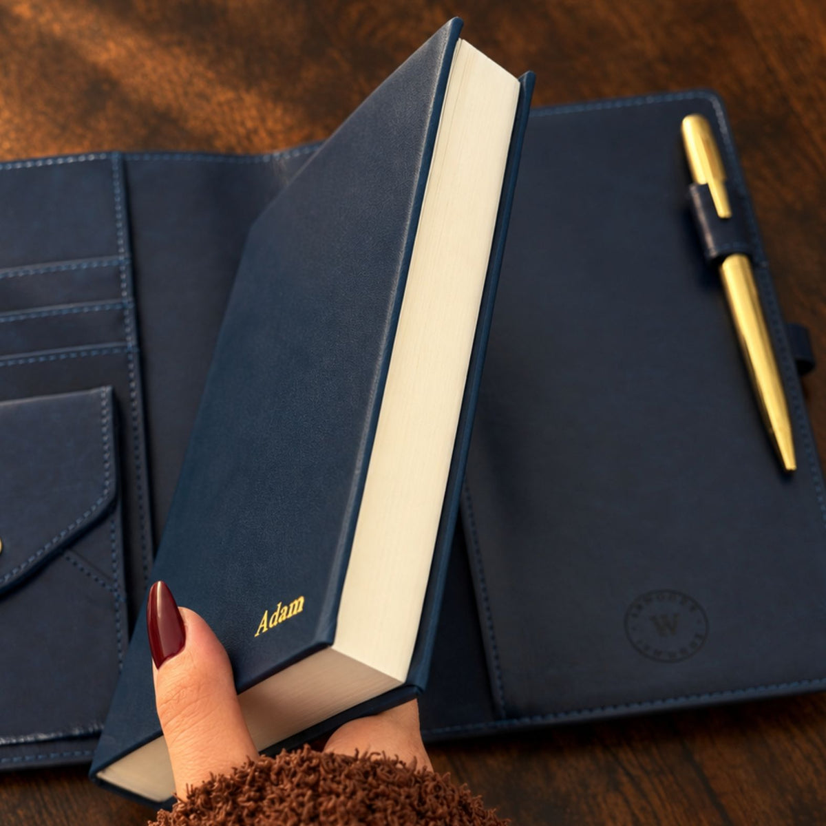 Navy blue Mémoire journal by Inwords Gifting, featuring a hardcover with gold embossed title and lined pages inside.