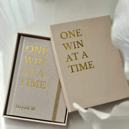 Inwords Gifting One Win at a Time Notebook with a motivational cover design and lined pages for journaling or note-taking.
